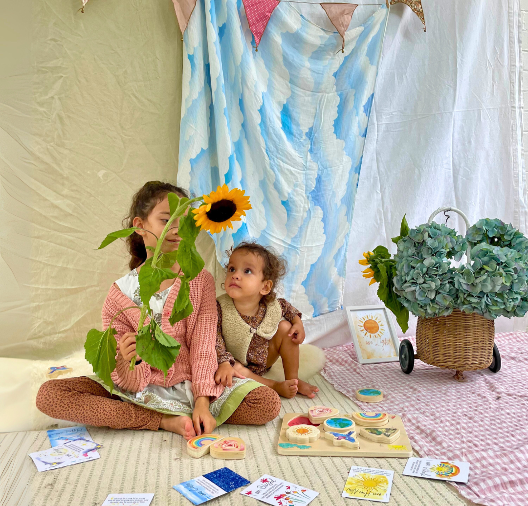 Two children playing with sunchild educational toys and plants in a home setting.